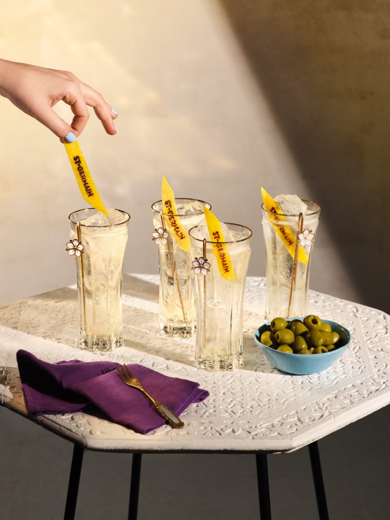 St-Germain cocktails with citrus garnish on textured table, lifestyle drinks photography