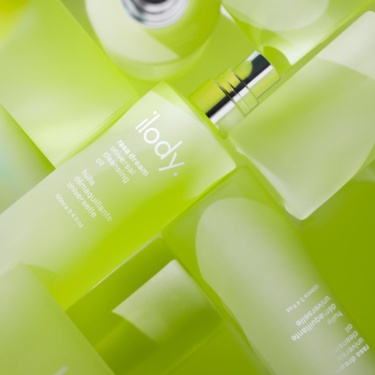 Close-up of Ilody green bottle in a bright studio composition