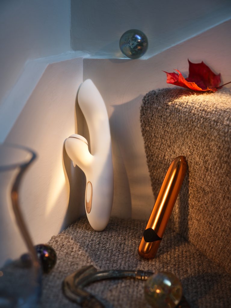 Minimal still life with white sculptural intimate object and metallic cylinder on stone steps