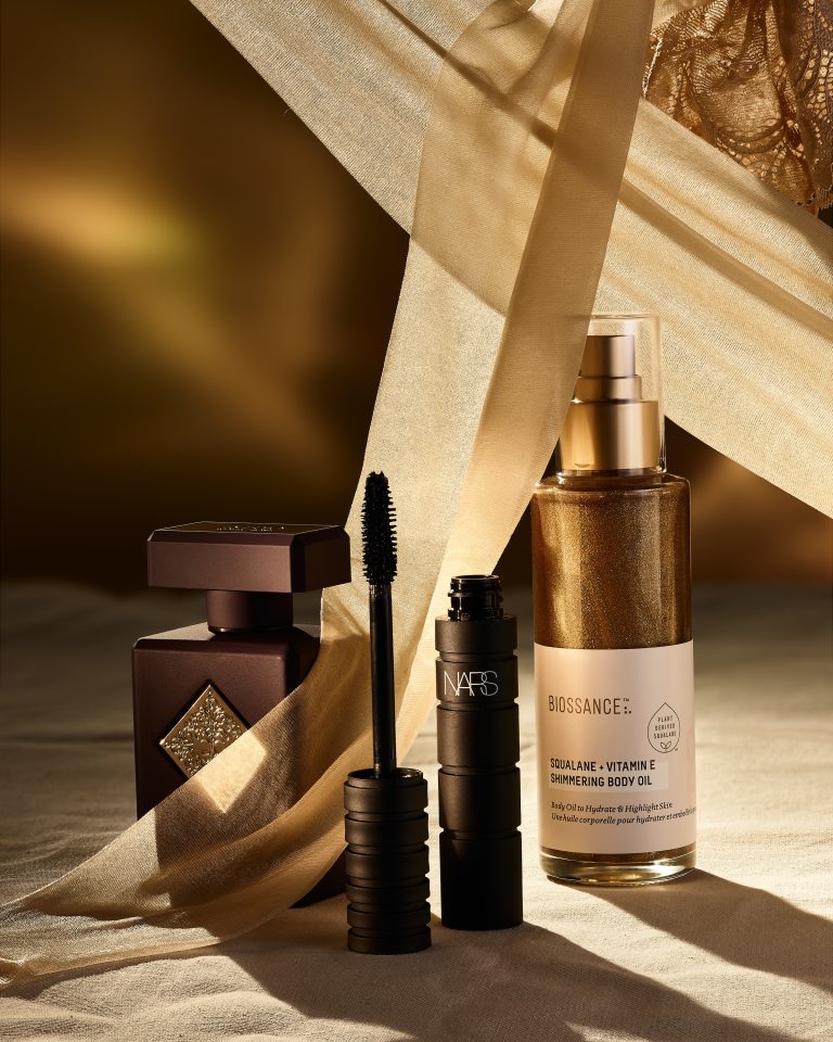 Skincare spray bottle with mascara and beauty products in editorial still life