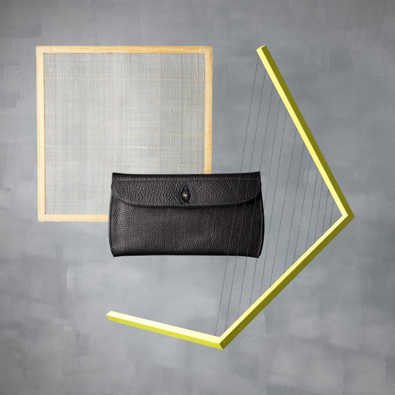 Mark Tallowin Pochette leather clutch against geometric studio backdrop