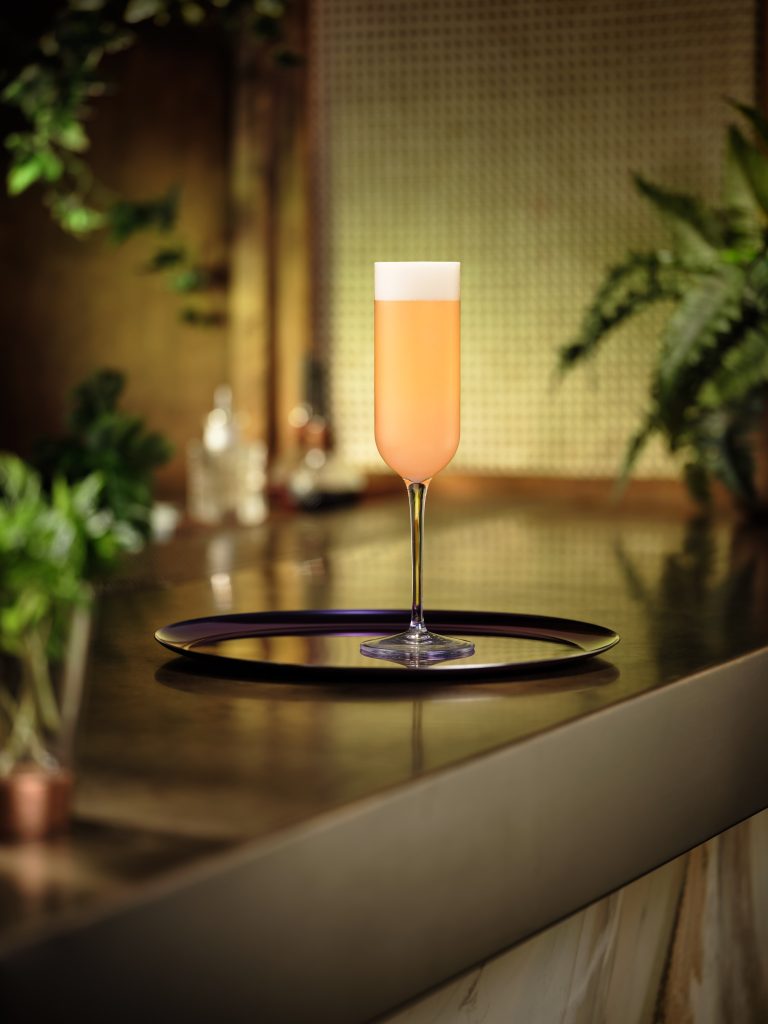 Pink cocktail in flute glass on tray at Nine Lives cocktail bar