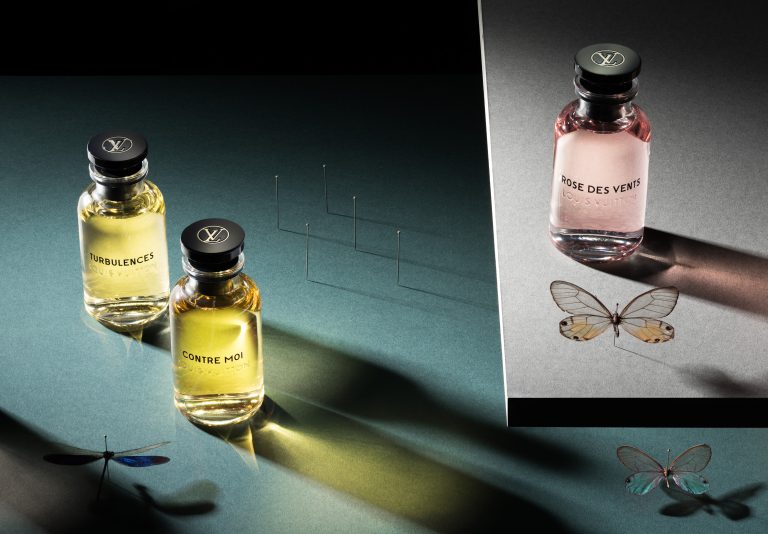Louis Vuitton fragrance bottles in directional light with butterfly detail, editorial still life