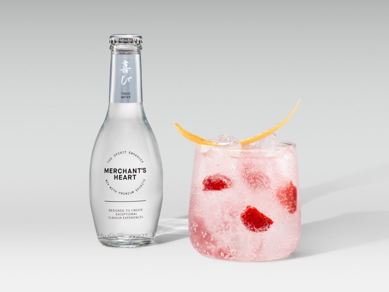 Merchant’s Heart bottle with pink cocktail and berry garnish