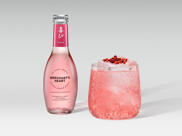Merchant’s Heart pink mixer bottle with iced cocktail and crushed garnish