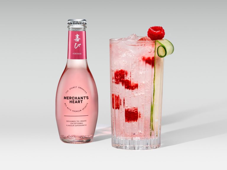 Merchant’s Heart pink mixer bottle with iced cocktail, raspberry and cucumber garnish