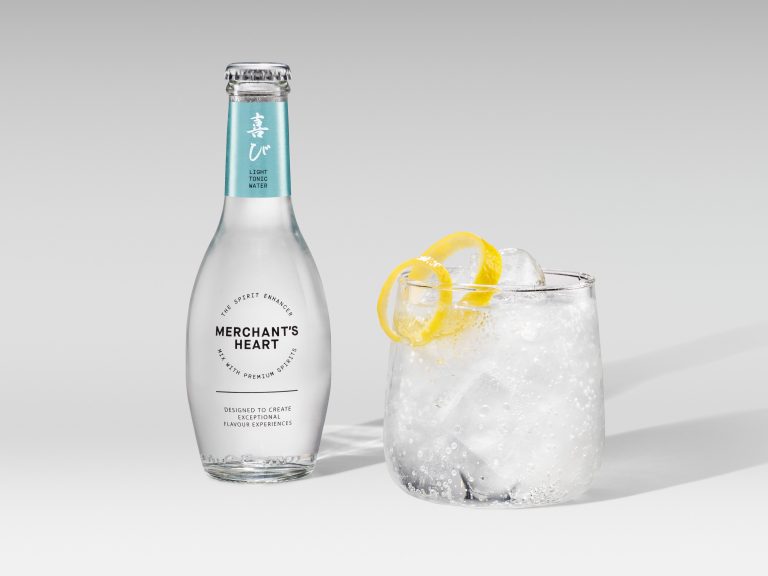 Merchant’s Heart tonic bottle with short iced drink and lemon peel garnish