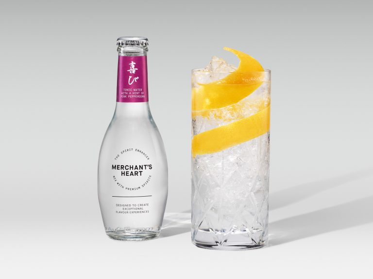 Merchant’s Heart bottle with tall iced drink and orange peel spiral